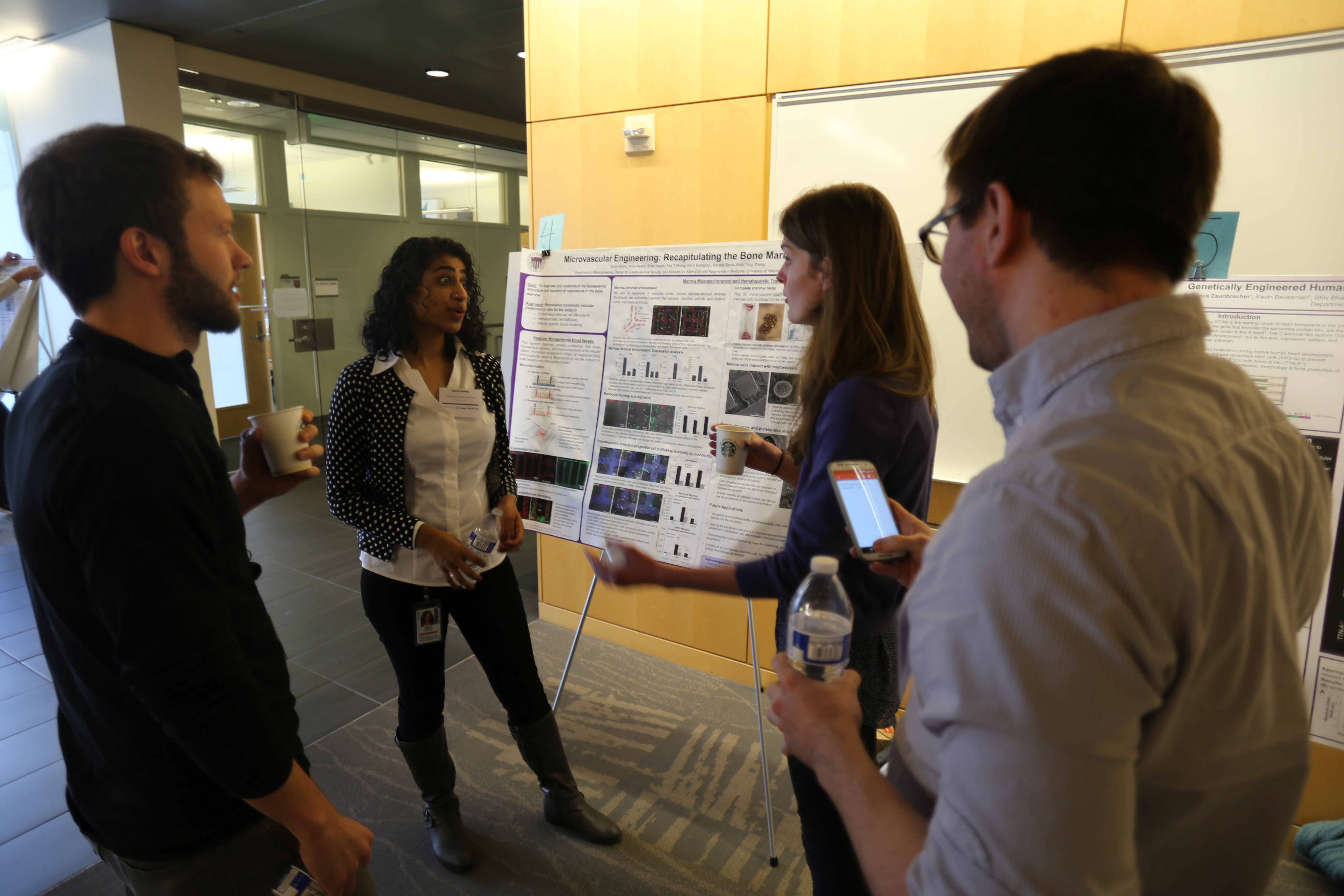 Students discussing research poster