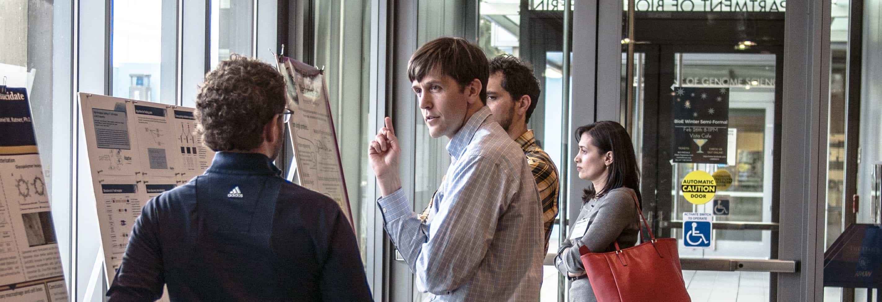 Students discussing a research poster